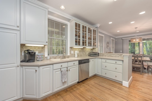 kitchen featuring white cabinetry, kitchen peninsula, and dishwasher