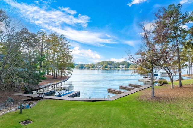 dock area featuring a water view and a lawn
