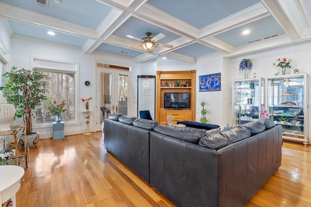 living room featuring visible vents, beam ceiling, light wood-style floors, and coffered ceiling