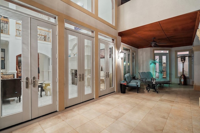 sunroom / solarium featuring wood ceiling and french doors