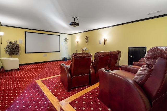 carpeted cinema room with visible vents, baseboards, and ornamental molding