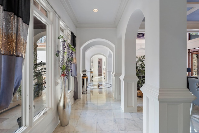 entrance foyer featuring recessed lighting, arched walkways, and ornamental molding