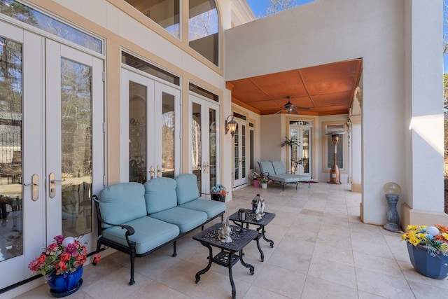 view of patio with an outdoor living space, french doors, and ceiling fan