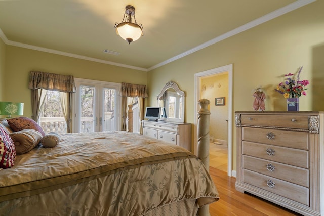 bedroom featuring access to exterior, visible vents, light wood finished floors, crown molding, and french doors