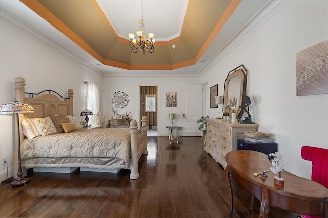 bedroom featuring wood finished floors, visible vents, a tray ceiling, crown molding, and a chandelier