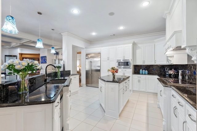 kitchen featuring a kitchen island, light tile patterned flooring, a sink, built in appliances, and backsplash