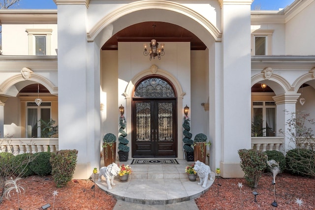 entrance to property with french doors and stucco siding