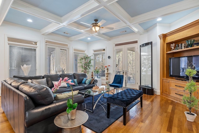 living area featuring coffered ceiling, light wood finished floors, beam ceiling, recessed lighting, and french doors