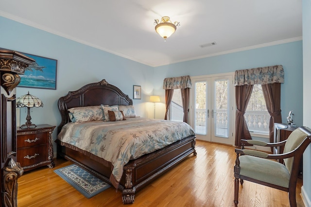 bedroom featuring access to exterior, french doors, visible vents, and light wood-type flooring