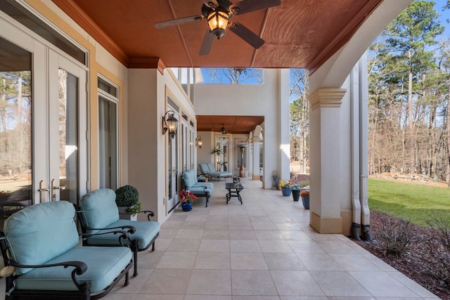 view of patio / terrace featuring a ceiling fan and french doors