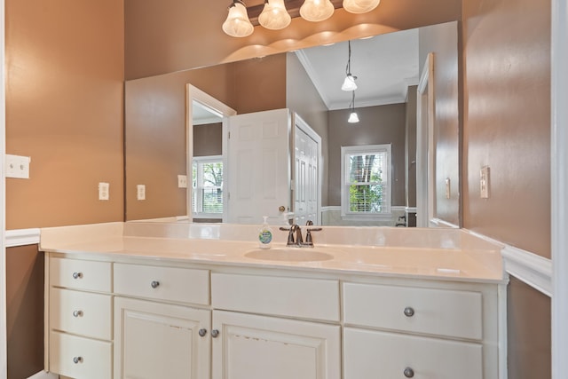 bathroom featuring ornamental molding and vanity