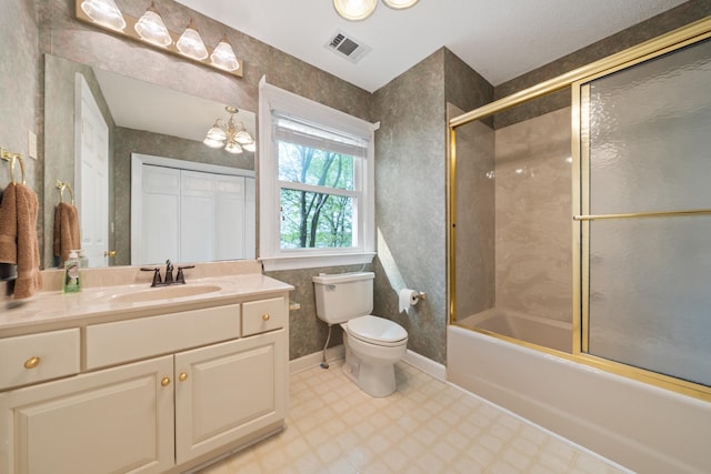 bathroom featuring shower / bath combination with glass door, vanity, toilet, tile patterned floors, and visible vents