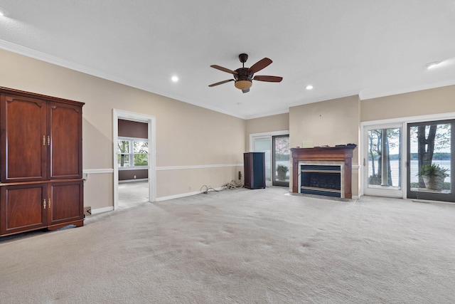 unfurnished living room featuring recessed lighting, a ceiling fan, a fireplace with flush hearth, and light carpet