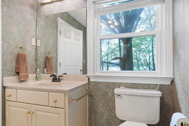 half bathroom with vanity and toilet