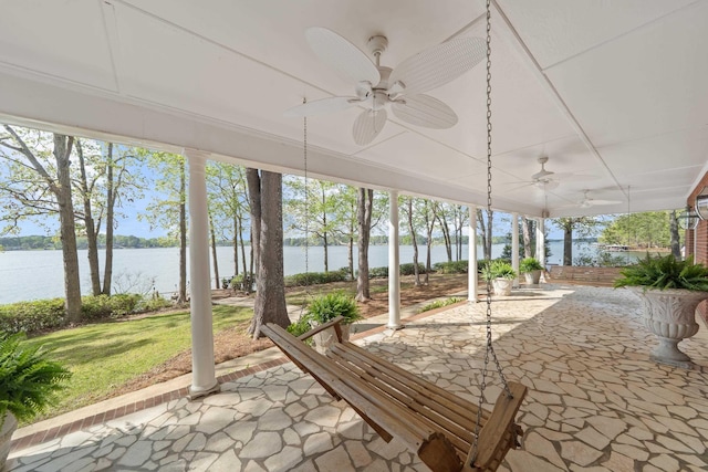 view of patio / terrace featuring a water view and ceiling fan