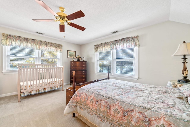 carpeted bedroom featuring visible vents, baseboards, and ceiling fan