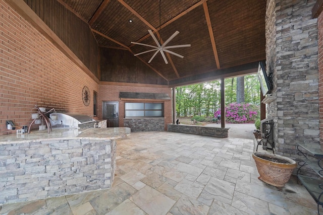 view of patio / terrace with an outdoor kitchen, a ceiling fan, a gazebo, and a grill