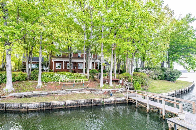 back of property featuring a deck with water view