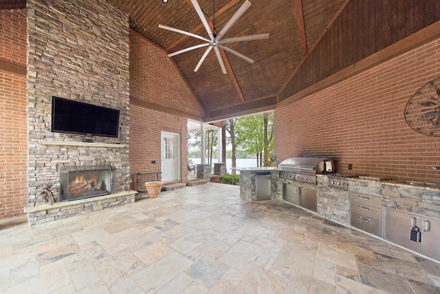 view of patio with an outdoor stone fireplace, ceiling fan, grilling area, and area for grilling