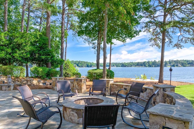 view of patio / terrace with a water view and an outdoor fire pit