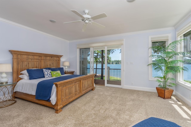 carpeted bedroom featuring access to outside, ornamental molding, ceiling fan, and a water view