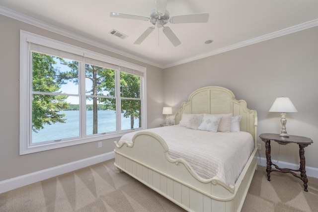 carpeted bedroom featuring a water view, ceiling fan, and ornamental molding