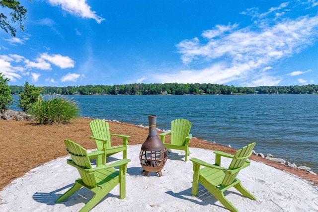 view of patio / terrace with a water view and an outdoor fire pit