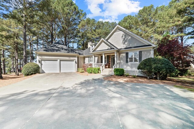 100 Indian Trl, Eatonton, GA 31024 - view of front facade featuring a porch, an attached garage, and concrete driveway