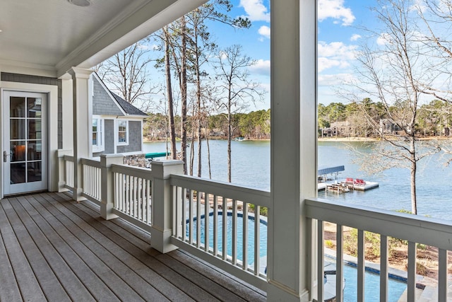 deck with a swimming pool and a water view