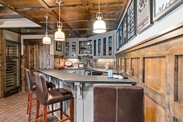 kitchen featuring a peninsula, glass insert cabinets, wood ceiling, dark countertops, and tasteful backsplash