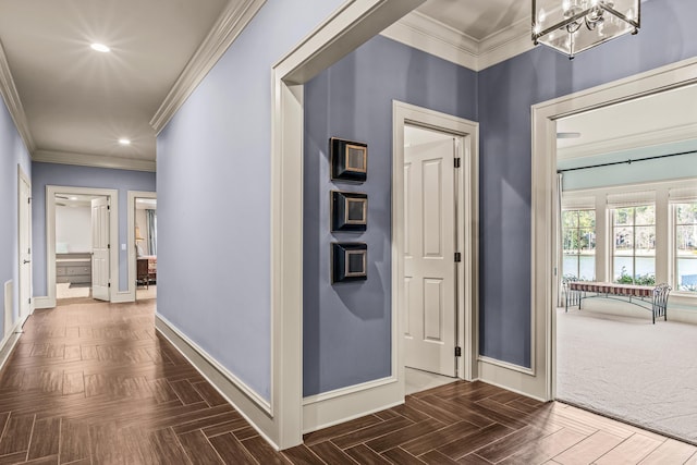 corridor with recessed lighting, baseboards, a chandelier, and ornamental molding