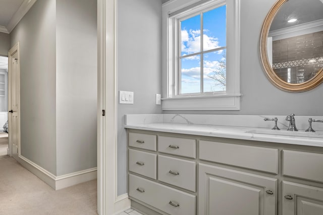 bathroom featuring vanity, baseboards, and ornamental molding