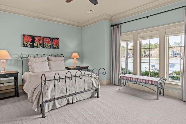 carpeted bedroom featuring visible vents, multiple windows, and ornamental molding