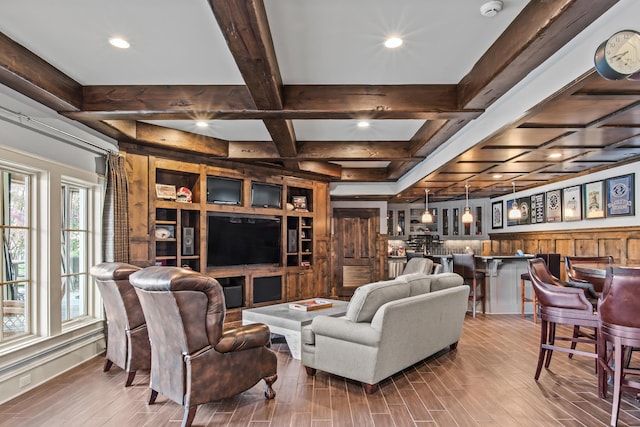 living room with beamed ceiling, coffered ceiling, wood finished floors, recessed lighting, and wet bar