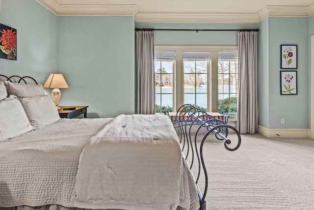 bedroom with baseboards, a water view, carpet flooring, and crown molding