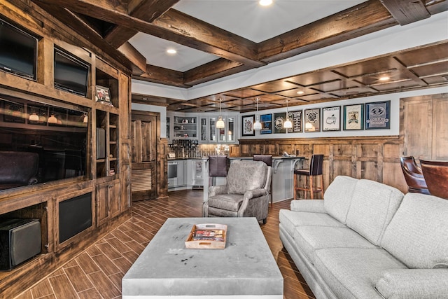 living room with indoor wet bar, coffered ceiling, beamed ceiling, and dark wood-style floors