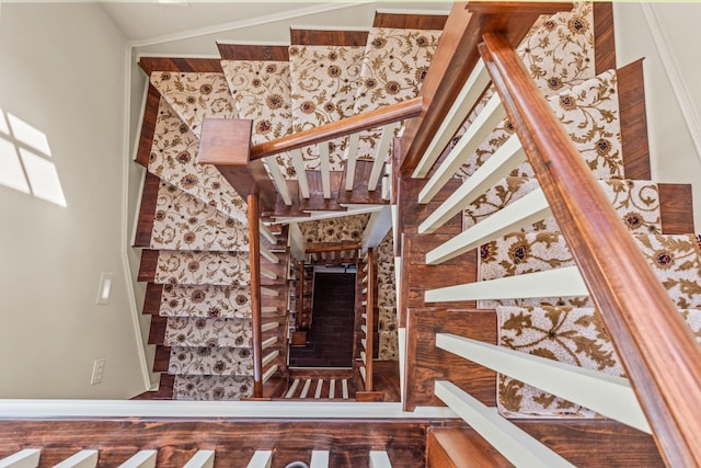 stairs with lofted ceiling and wood finished floors