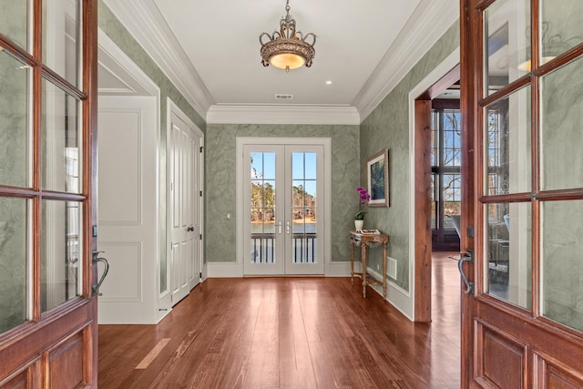 foyer with baseboards, visible vents, ornamental molding, dark wood-type flooring, and french doors