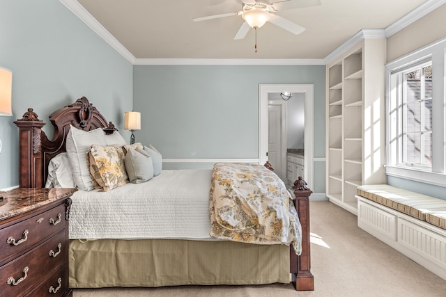 bedroom featuring light carpet, ornamental molding, ensuite bath, baseboards, and ceiling fan