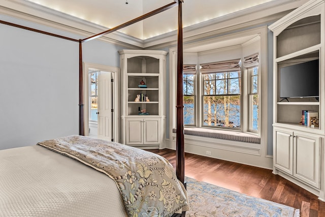 bedroom with dark wood finished floors and crown molding