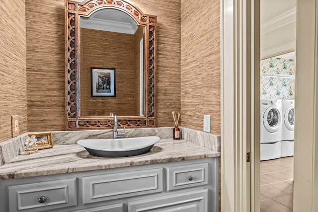 bathroom featuring vanity, separate washer and dryer, crown molding, and tile patterned flooring