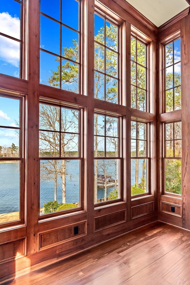 doorway featuring a water view and wood finished floors