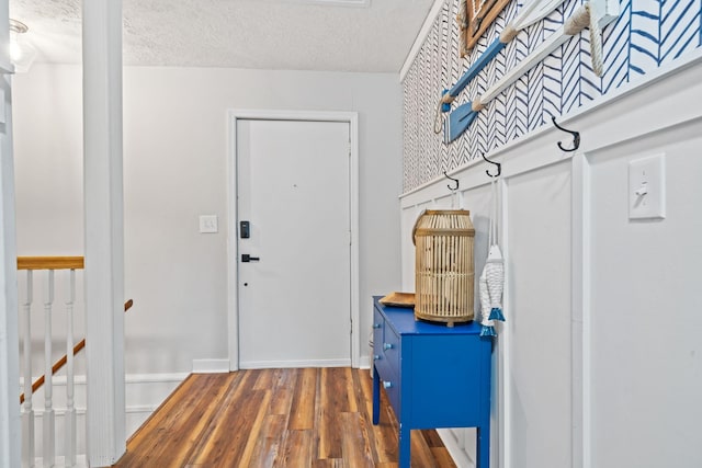 entryway with dark hardwood / wood-style floors and a textured ceiling