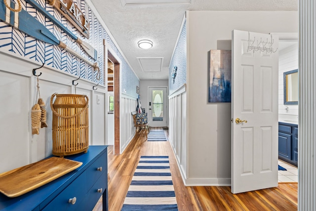 corridor featuring hardwood / wood-style flooring and a textured ceiling