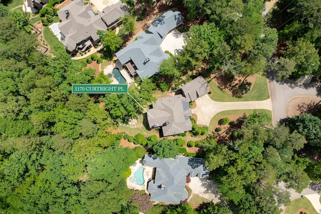 view of property location with a pool and nearby suburban area