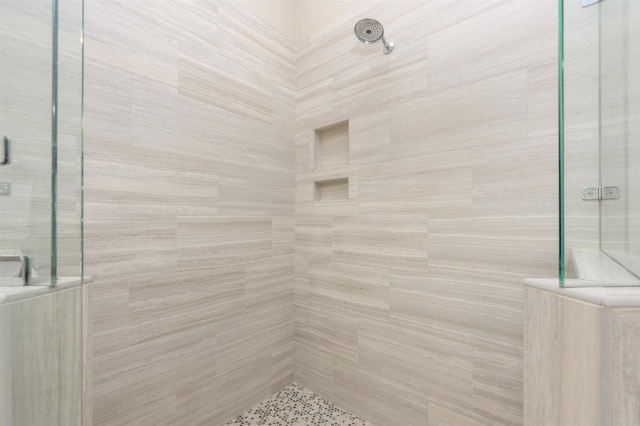 bathroom with a tile shower
