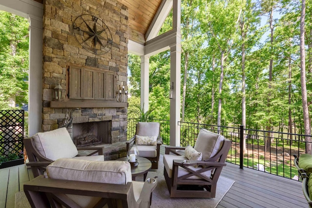 sunroom / solarium with vaulted ceiling and an outdoor living space with a fireplace