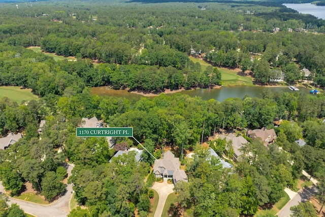 bird's eye view of a nearby body of water and a heavily wooded area