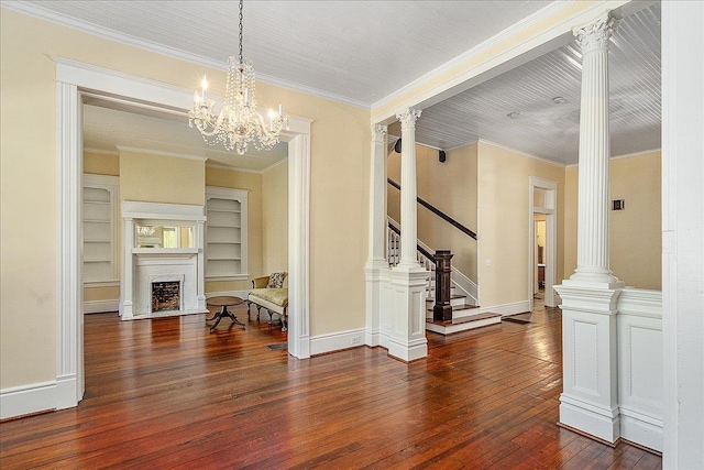 dining area featuring crown molding, dark wood-type flooring, and ornate columns