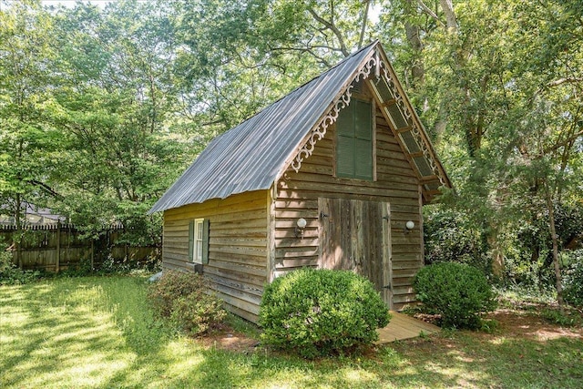 view of outbuilding with a lawn